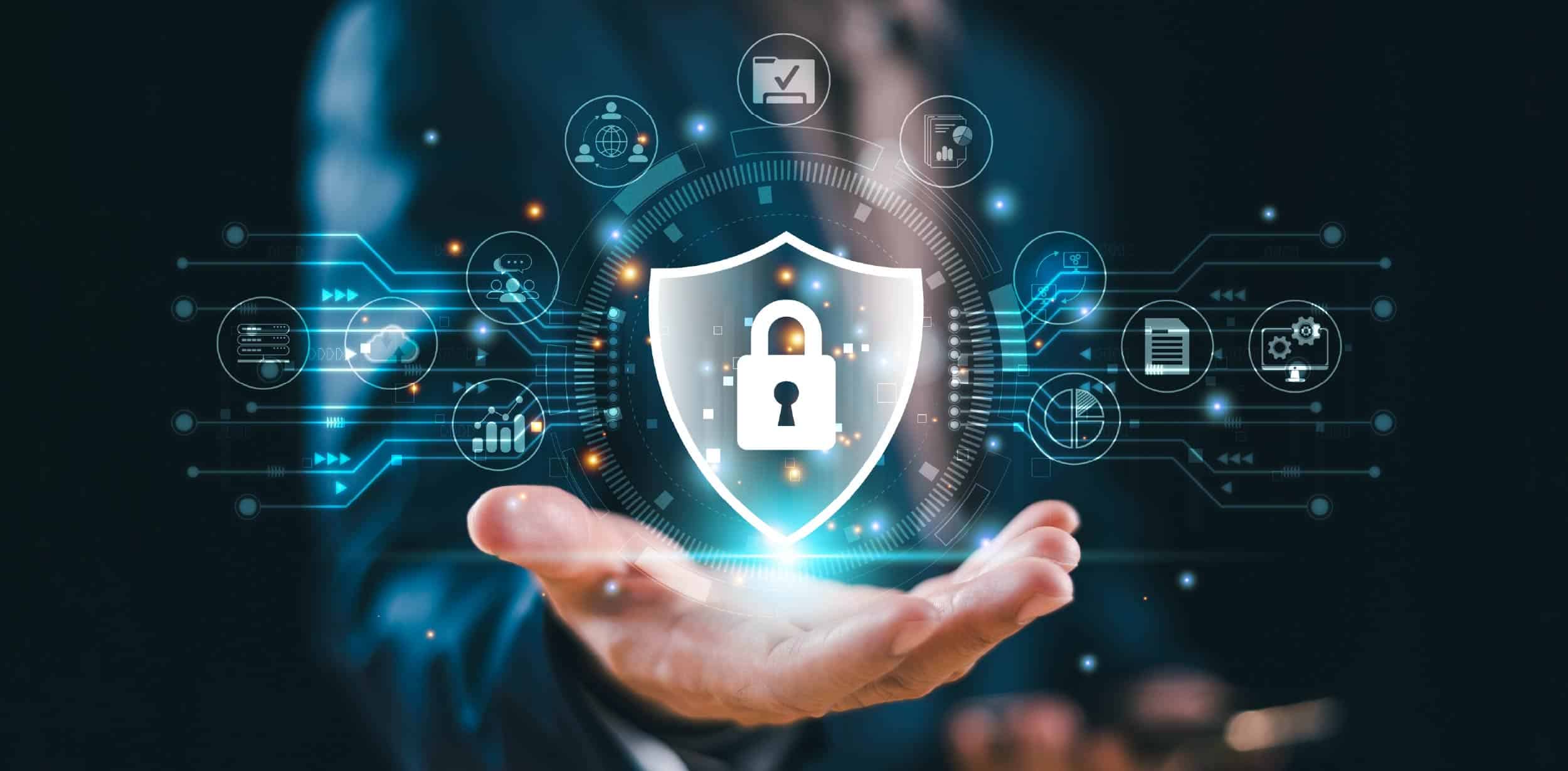 Businessperson presenting a digital shield icon with locked padlock and cybersecurity network symbols signifying protection against modern cyber breaches